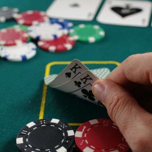 person holding white and black playing cards